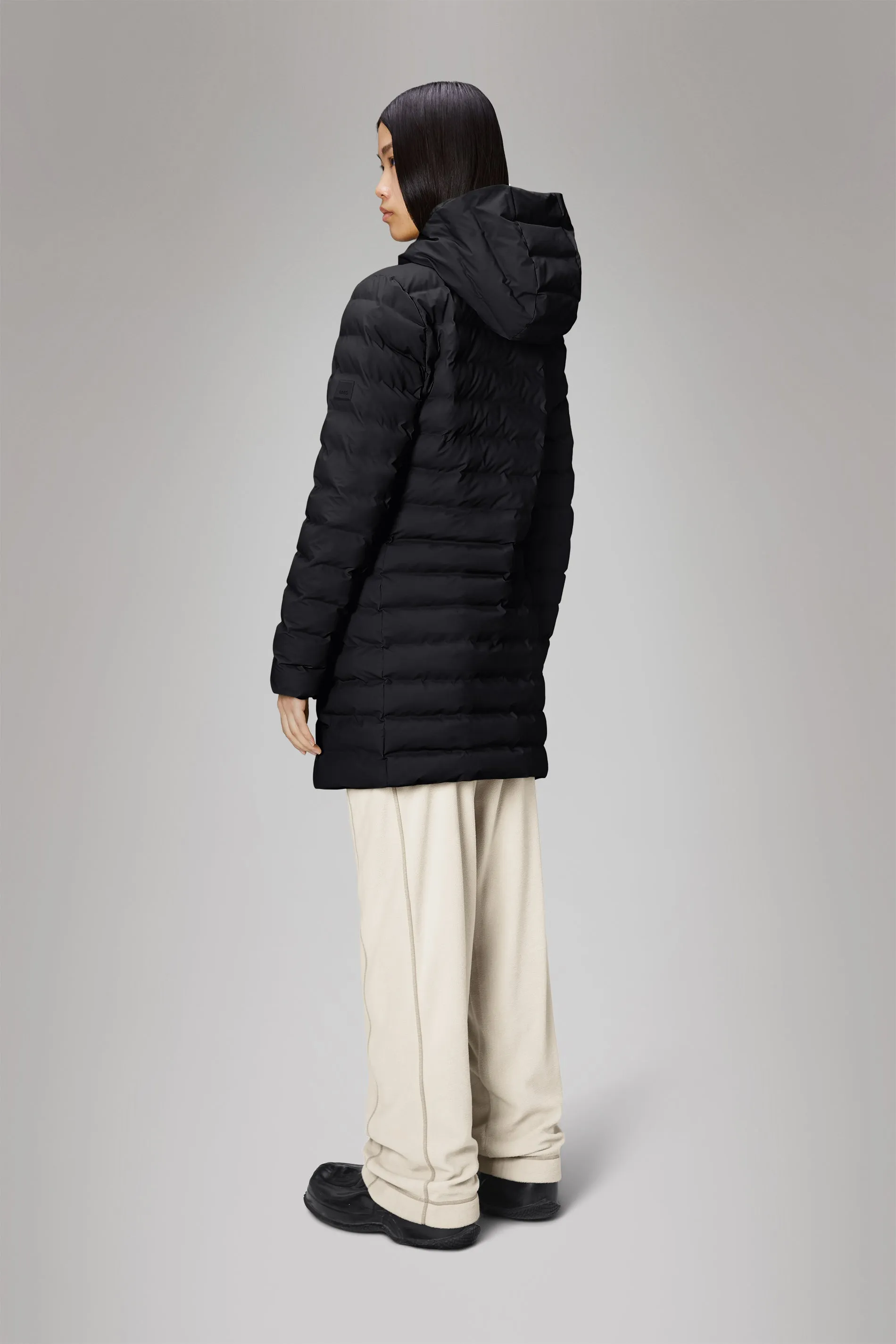 Rains® Lohja Long Puffer Curve Jacket in Black for €299 | 2-Year Warranty